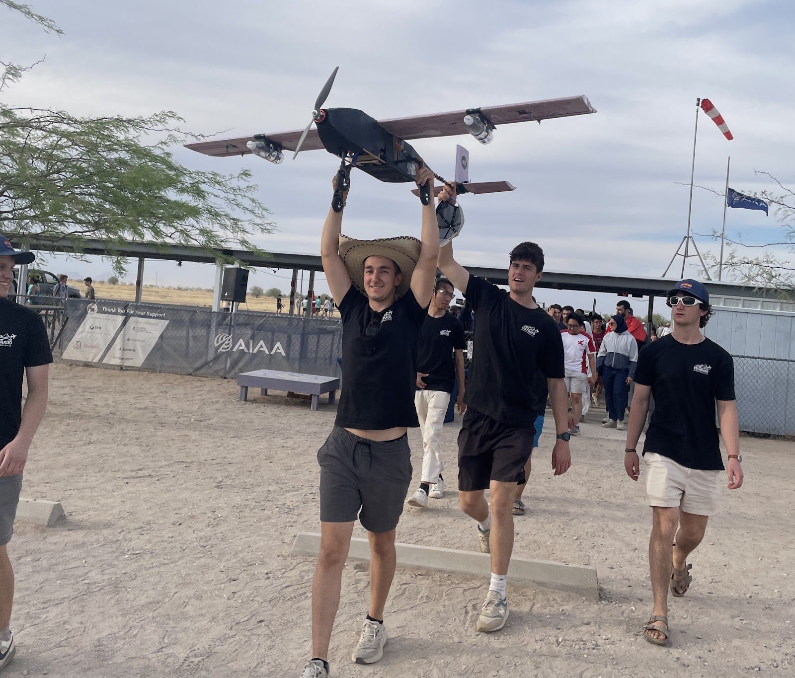 Colorado DBF members carrying the competition aircraft off the flight line